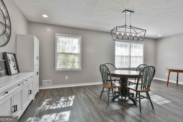 325 Sweetbriar Ln, Griffin, GA 30224 - dining space with visible vents, baseboards, dark wood-style flooring, a chandelier, and a textured ceiling