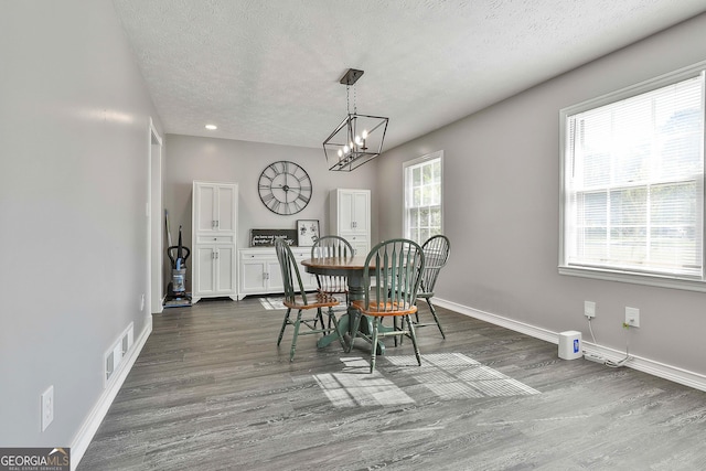 325 Sweetbriar Ln, Griffin, GA 30224 - dining area with visible vents, baseboards, a chandelier, a textured ceiling, and dark wood-type flooring