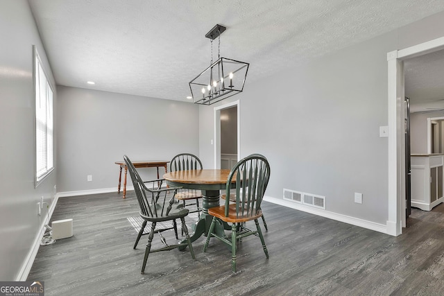 325 Sweetbriar Ln, Griffin, GA 30224 - dining space with dark wood-type flooring, visible vents, baseboards, and a textured ceiling