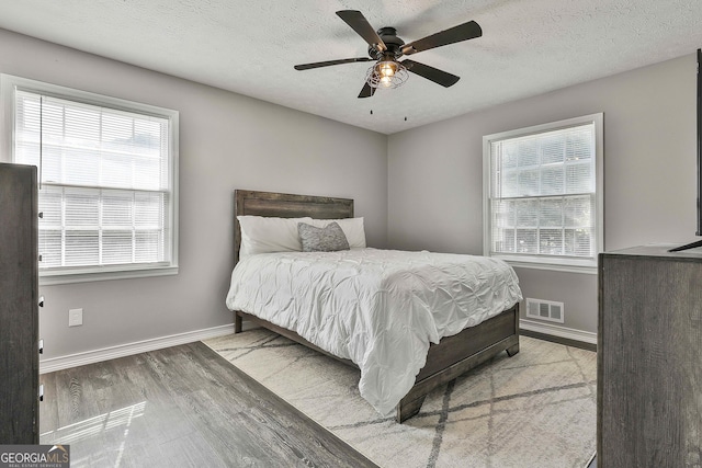 325 Sweetbriar Ln, Griffin, GA 30224 - bedroom with a textured ceiling, wood finished floors, baseboards, and visible vents
