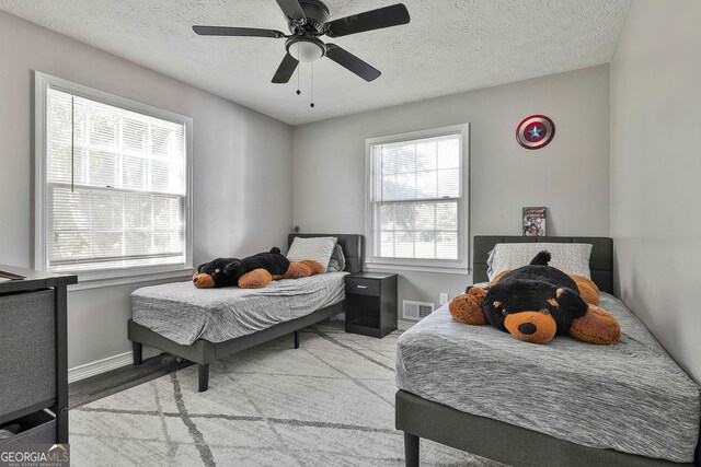 325 Sweetbriar Ln, Griffin, GA 30224 - bedroom with visible vents, a textured ceiling, baseboards, and ceiling fan