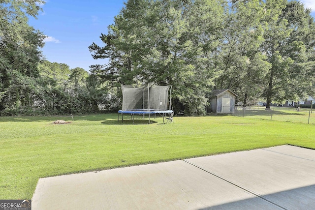 325 Sweetbriar Ln, Griffin, GA 30224 - view of yard with an outbuilding, fence, a trampoline, and a patio