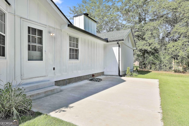 325 Sweetbriar Ln, Griffin, GA 30224 - property entrance with a yard, a patio, board and batten siding, and a chimney