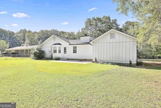325 Sweetbriar Ln, Griffin, GA 30224 - rear view of property with entry steps, a yard, a chimney, board and batten siding, and fence