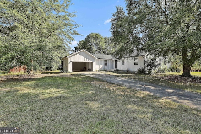 325 Sweetbriar Ln, Griffin, GA 30224 - view of front facade with an attached garage, driveway, board and batten siding, and a front lawn