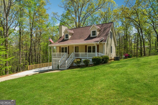 388 Pine Trl, Canton, GA 30115 - cape cod house with a shingled roof, covered porch, a chimney, a front lawn, and driveway