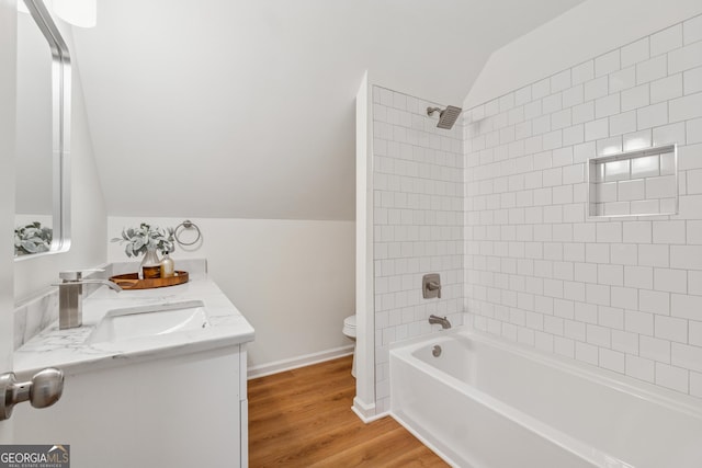 388 Pine Trl, Canton, GA 30115 - bathroom featuring a sink, toilet, bathtub / shower combination, vaulted ceiling, and wood finished floors