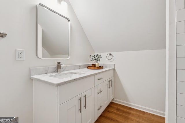 388 Pine Trl, Canton, GA 30115 - bathroom featuring wood finished floors, vanity, baseboards, and vaulted ceiling