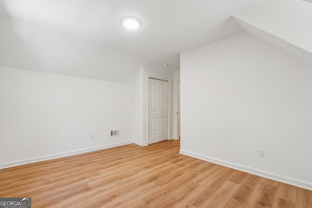 388 Pine Trl, Canton, GA 30115 - additional living space featuring visible vents, baseboards, light wood-type flooring, and vaulted ceiling
