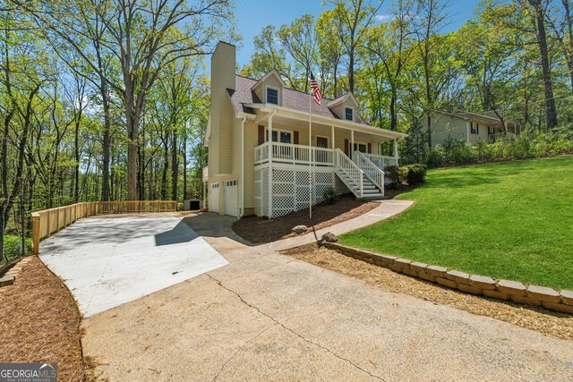 388 Pine Trl, Canton, GA 30115 - view of front of home with a chimney, driveway, a front yard, a garage, and covered porch