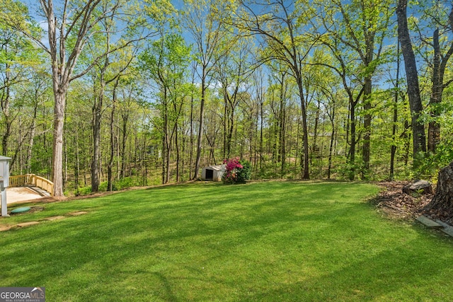388 Pine Trl, Canton, GA 30115 - view of yard featuring a view of trees, a shed, and an outdoor structure