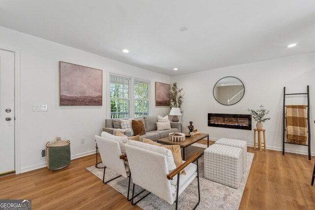 388 Pine Trl, Canton, GA 30115 - living area with a glass covered fireplace, recessed lighting, light wood-type flooring, and baseboards
