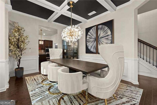 dining room with a notable chandelier, stairs, coffered ceiling, a decorative wall, and wood finished floors