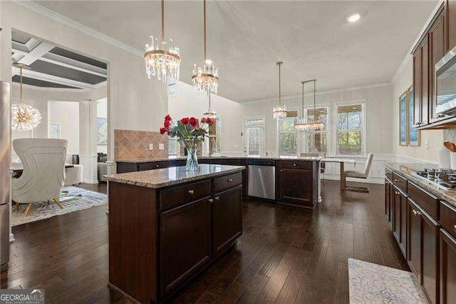 kitchen with an inviting chandelier, dark wood-style floors, a kitchen island, coffered ceiling, and appliances with stainless steel finishes