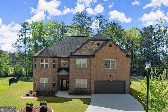 view of front of home featuring a front yard, a garage, and driveway