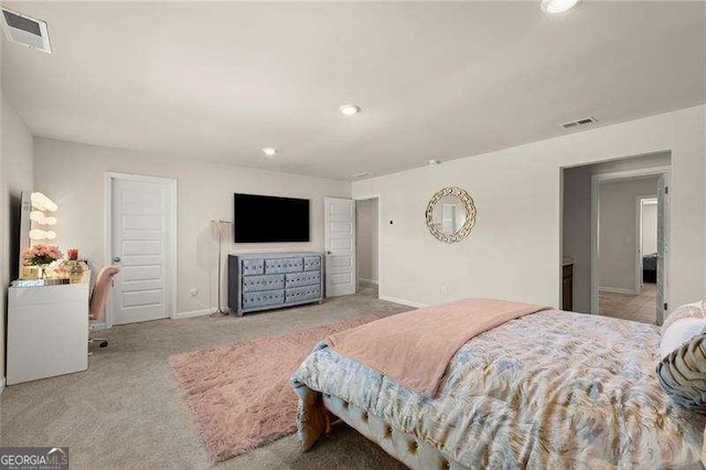 carpeted bedroom featuring visible vents and baseboards