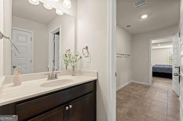 bathroom featuring vanity, baseboards, tile patterned flooring, and visible vents