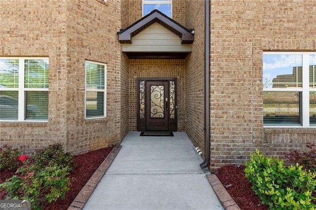 property entrance with brick siding