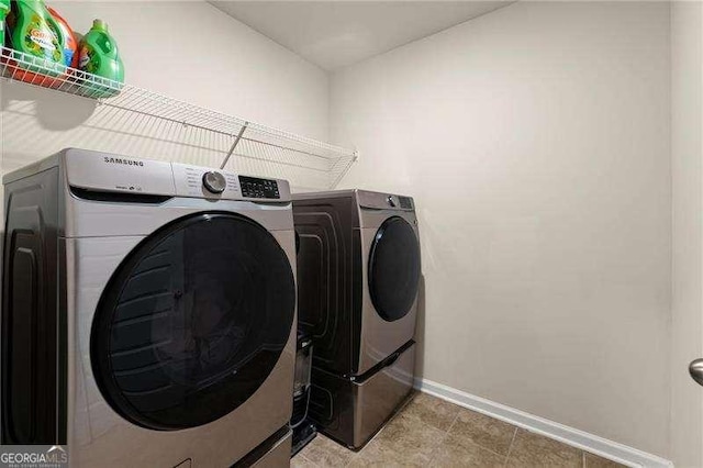 laundry area with washer and dryer, laundry area, and baseboards