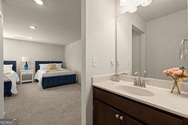 bathroom with ensuite bathroom, recessed lighting, and vanity