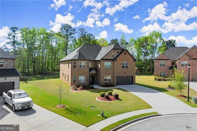 view of front of property featuring concrete driveway, a front yard, and an attached garage