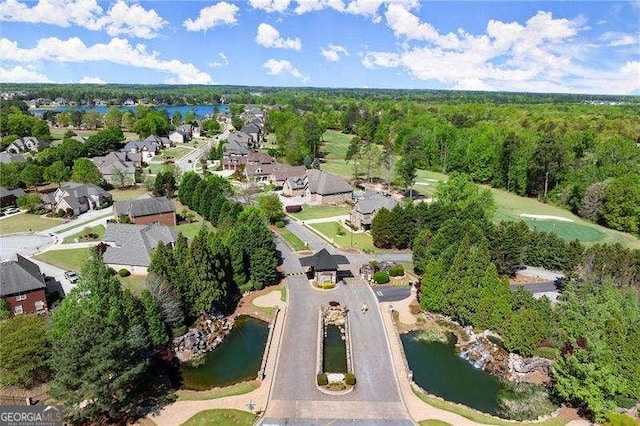 birds eye view of property with a water view, a forest view, and a residential view