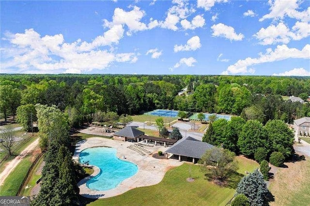 birds eye view of property with a forest view