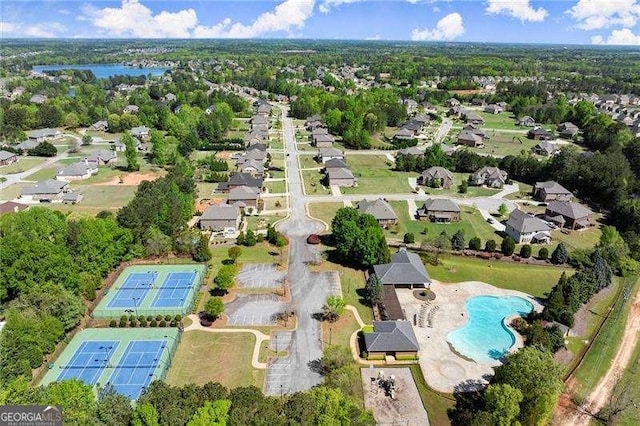 drone / aerial view with a water view and a residential view