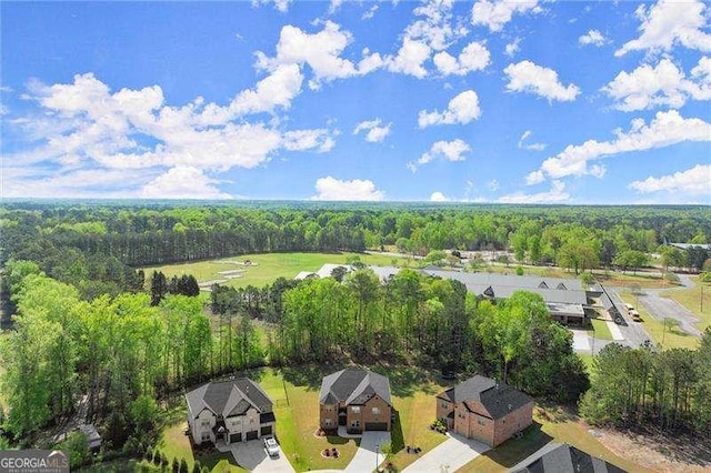 bird's eye view featuring a view of trees and a residential view
