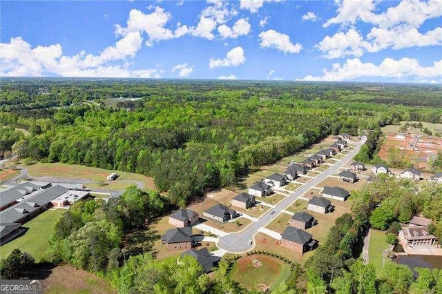 birds eye view of property featuring a view of trees and a residential view