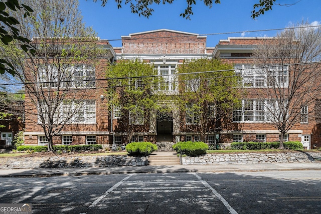 view of building exterior with uncovered parking