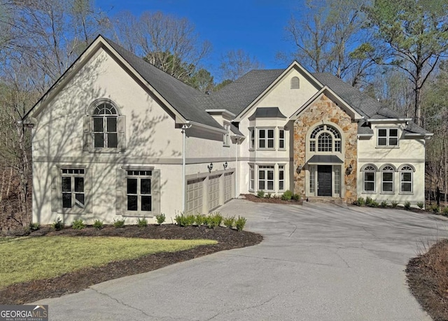 view of front facade featuring concrete driveway, stucco siding, stone siding, and a garage