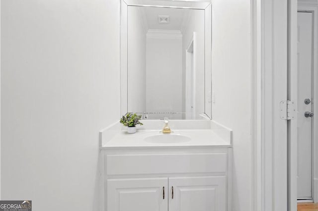 bathroom featuring vanity and crown molding