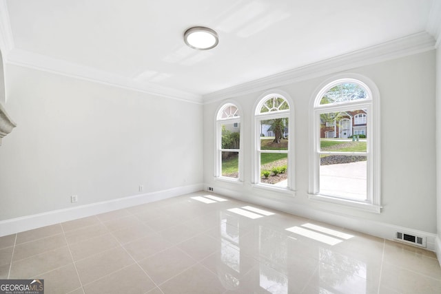 unfurnished room with tile patterned flooring, ornamental molding, visible vents, and a wealth of natural light