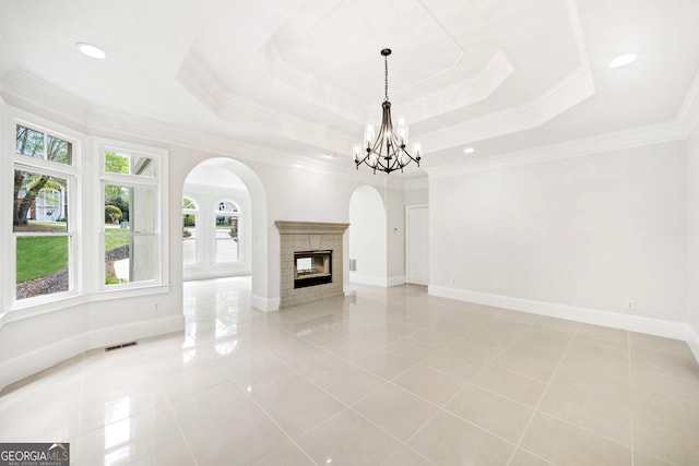 unfurnished living room featuring arched walkways, visible vents, plenty of natural light, and light tile patterned floors