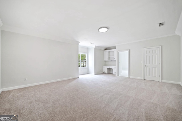 unfurnished living room with crown molding, visible vents, baseboards, and light colored carpet