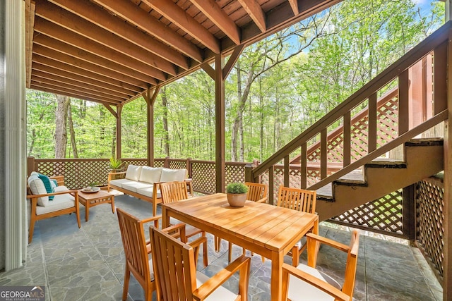 view of patio with outdoor dining space, an outdoor hangout area, and stairway