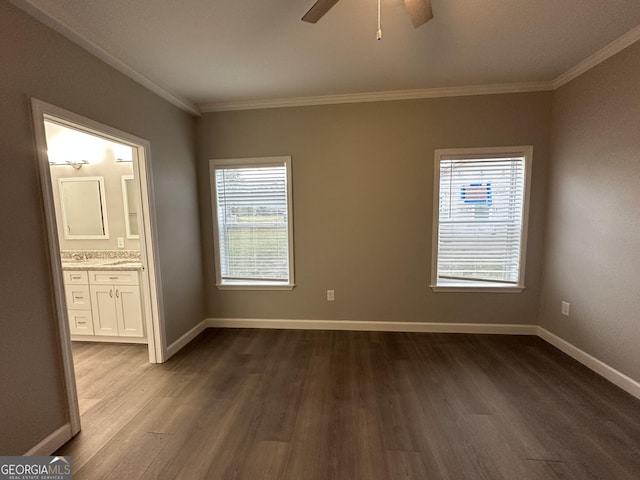 16 Pear St, Ludowici, GA 31316 - unfurnished bedroom featuring baseboards, a ceiling fan, crown molding, connected bathroom, and dark wood finished floors
