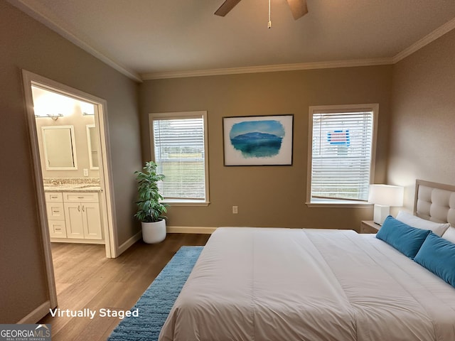 16 Pear St, Ludowici, GA 31316 - bedroom featuring crown molding, ceiling fan, connected bathroom, light wood-type flooring, and baseboards