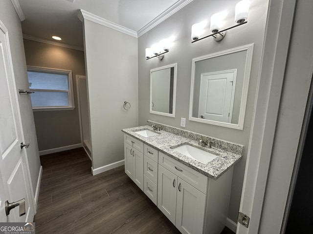 16 Pear St, Ludowici, GA 31316 - bathroom with a sink, ornamental molding, baseboards, and wood finished floors