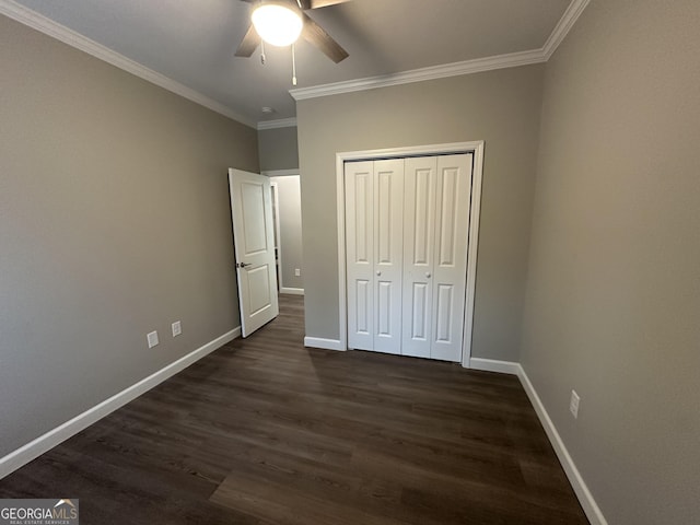 16 Pear St, Ludowici, GA 31316 - unfurnished bedroom with a closet, dark wood-style floors, baseboards, and crown molding