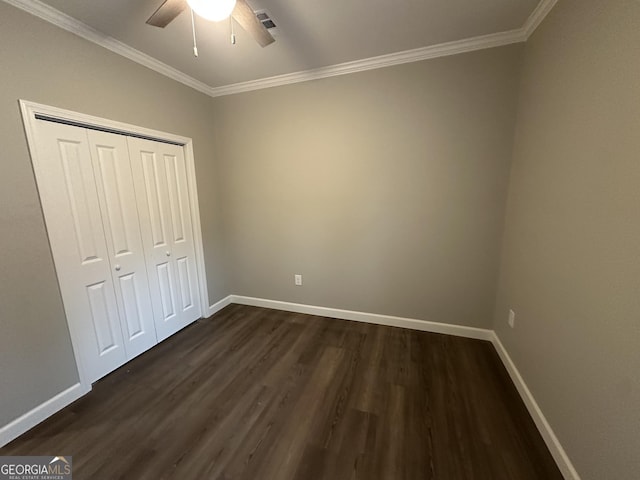 16 Pear St, Ludowici, GA 31316 - unfurnished bedroom featuring dark wood finished floors, a closet, ornamental molding, visible vents, and baseboards