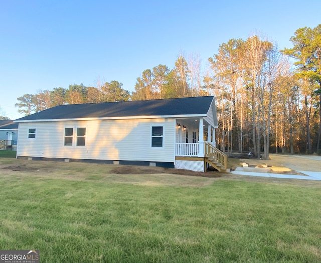 16 Pear St, Ludowici, GA 31316 - view of home's exterior with a yard and covered porch