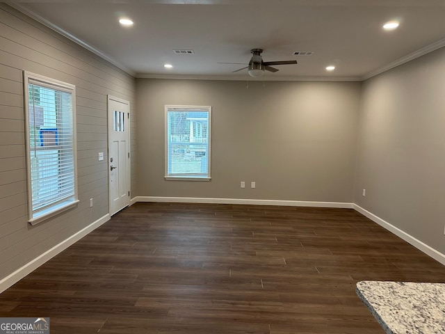 16 Pear St, Ludowici, GA 31316 - interior space with crown molding, ceiling fan, visible vents, baseboards, and dark wood-style floors