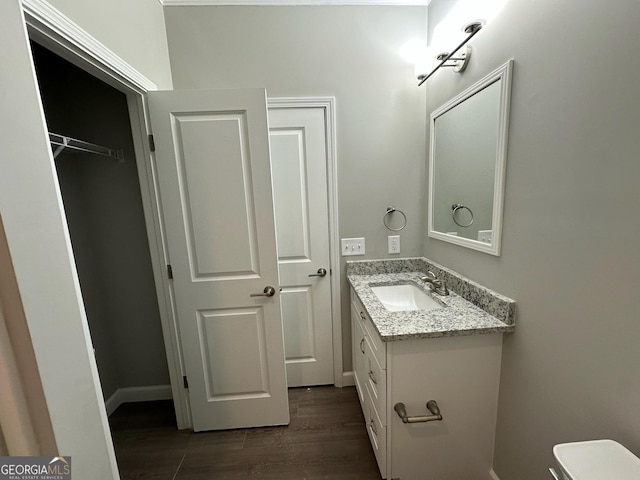 16 Pear St, Ludowici, GA 31316 - bathroom featuring toilet, wood finished floors, vanity, and baseboards