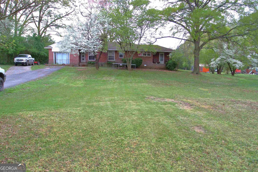483 Simmons St, Trion, GA 30753 - view of front of property with brick siding, a front yard, and asphalt driveway
