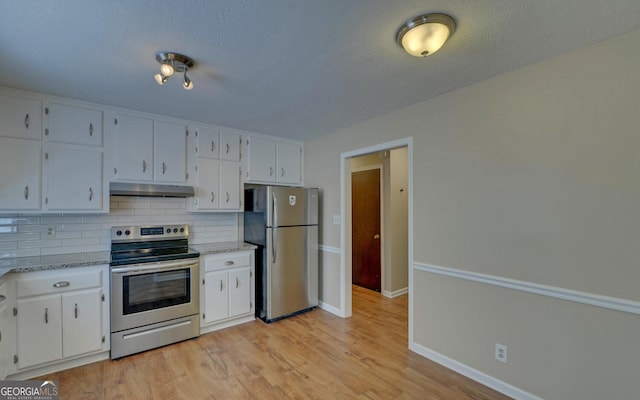 186 Foxdale Dr, Toccoa, GA 30577 - kitchen featuring decorative backsplash, baseboards, under cabinet range hood, white cabinets, and stainless steel appliances