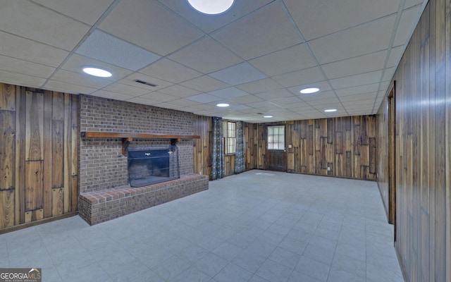186 Foxdale Dr, Toccoa, GA 30577 - below grade area featuring wooden walls, a brick fireplace, a drop ceiling, and visible vents