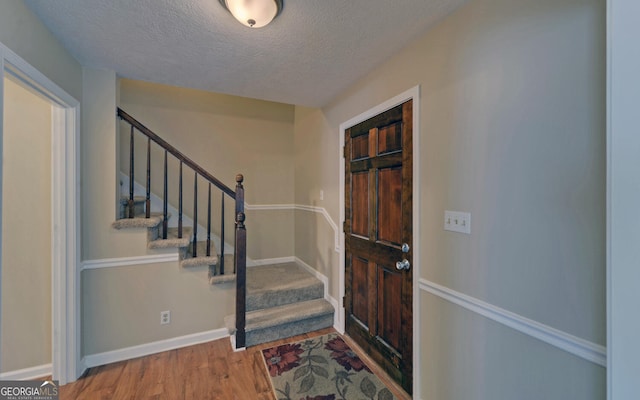 186 Foxdale Dr, Toccoa, GA 30577 - entryway with baseboards, a textured ceiling, wood finished floors, and stairway