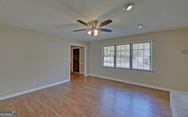 186 Foxdale Dr, Toccoa, GA 30577 - spare room featuring a textured ceiling, ceiling fan, visible vents, and wood finished floors
